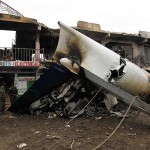 Security personnel secure scene where a cargo plane crashed into a commercial building at Utawala estate on outskirts of Kenya's capital Nairobi